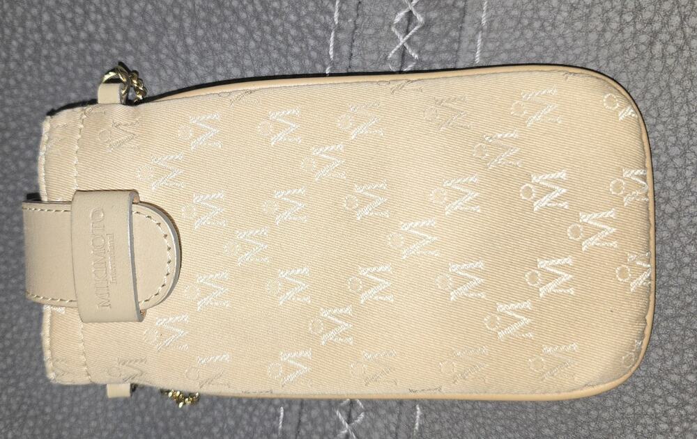 Mikimoto International monogrammed phone purse features a gold-toned chain strap